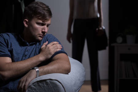 Irate woman coming back home to waiting husbandの写真素材