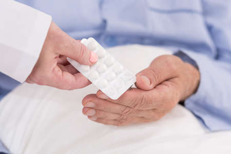 Close-up of pills in blister pack hold in hand