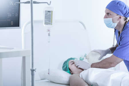 Horizontal picture of medic rescuing patient with manual respiratorの写真素材
