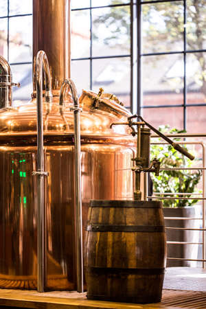 Photo of beer boiling kettle and cask in stylish restaurant