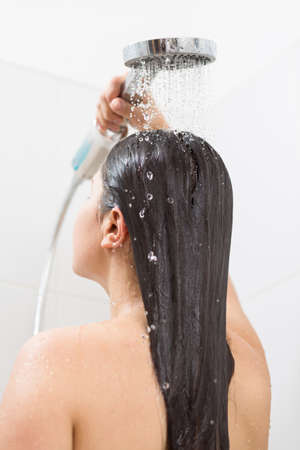 Image of woman washing hair under showerの写真素材
