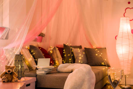 Fairy lights and baldachin in teen bedroomの写真素材