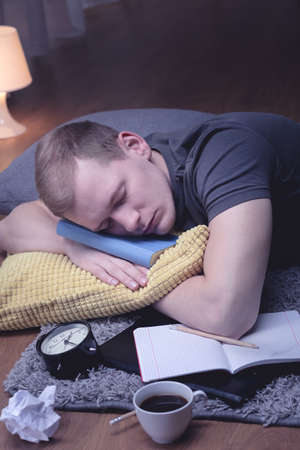 Image of study man sleeping with notebookの写真素材