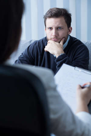 Image of psychiatrist listening to his male patientの写真素材