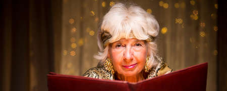 Old fortune teller is reading about magic