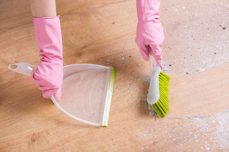 Close-up of sweeping the dust of the parquet