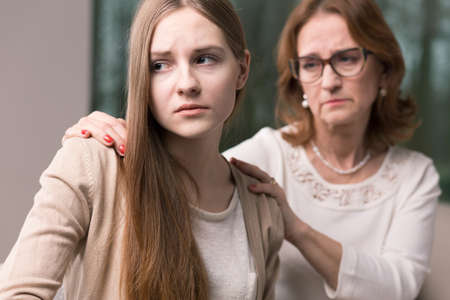 Teenage worried girl with problem and her supportive mother