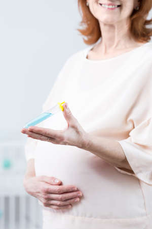 Older woman using in vitro holding test-tubeの写真素材