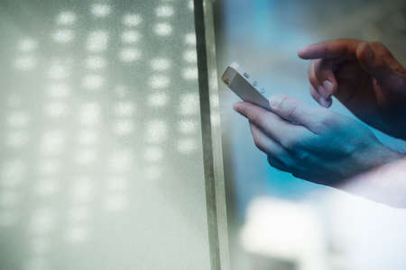 Multiple exposure of hands with phone and office