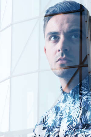 Double exposure of young handsome man and new bulding
