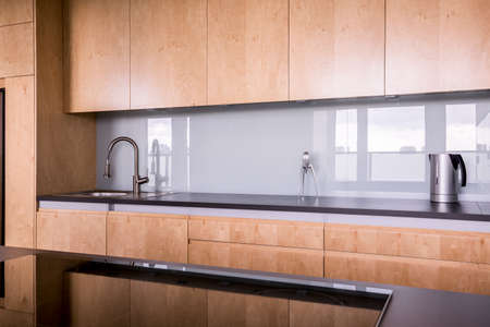 Wooden and clean cabinets in the kitchenの写真素材