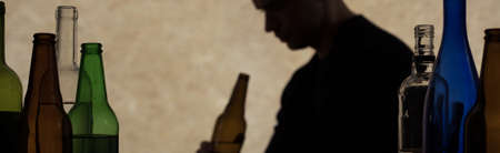 Young drinking man and serious alcohol problem