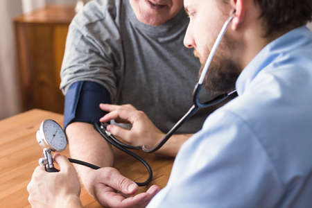 Hypertensive senior man during blood pressure measurement