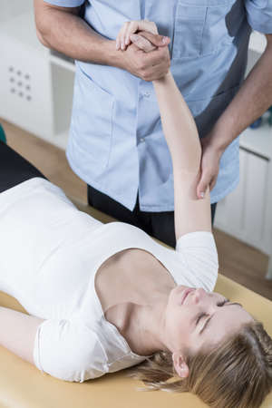 Young woman undergoing rehabilitation of injured arm