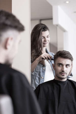 Young handsome man having a short haircutの写真素材