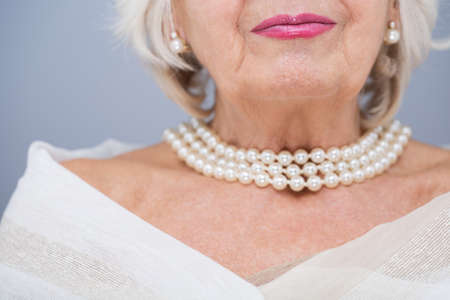 Senior woman with valuable pearl jewelleyの写真素材