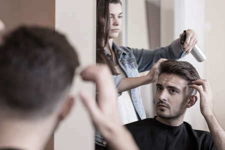 Handsome man visiting a hairdresserの写真素材