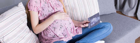 Young woman is looking at her ultrasound scan
