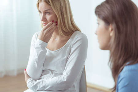 Young woman is very sad during group meetingの写真素材