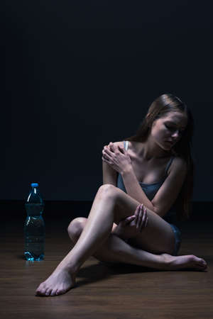 Skinny teenager with eating disorder and water dietの写真素材