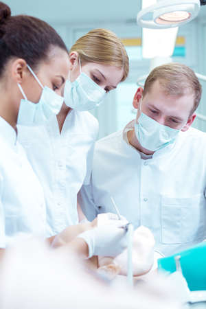 Dentistry students in medical uniforms with masks during classesの写真素材