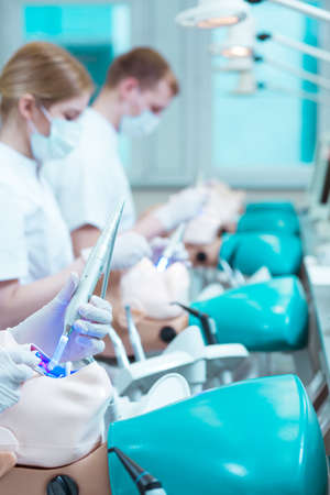 Students of dentistry training on dental manikinsの写真素材