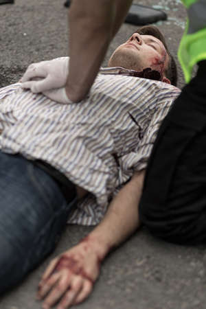 Policeman doing chest compression to injured manの写真素材