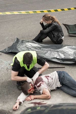 Female driver and policeman on car crash site