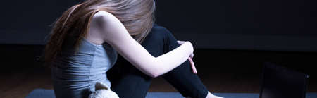 Young teen girl is feeling depressed and sad