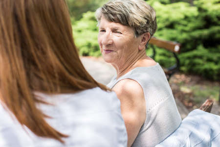 Elder lady is looking at her daughter