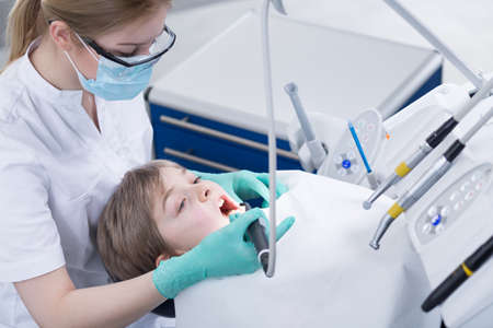 Shot of a little boy taking dental checkupの写真素材