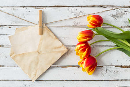 Shot of an envelope and a bunch of tulipsの写真素材