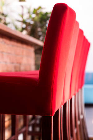 Red high chairs in front of barの写真素材