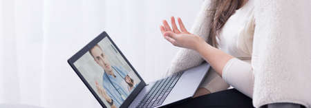 Young professional doctor using technology to treat the patient online