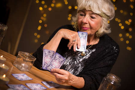 Fortune-teller forecasting the future from magic cardsの写真素材