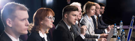 Image of a group of people sitting in a conference room