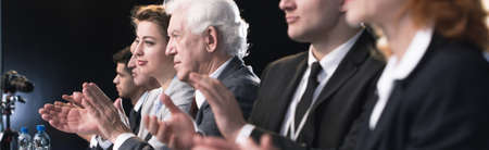 Image of a group of people clapping their hands