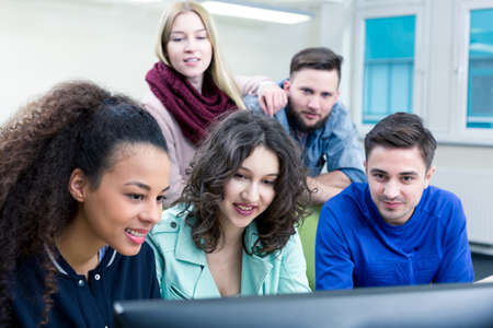Shot of a group of students working together during the IT classの写真素材