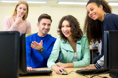 Shot of a group of happy students during the IT class