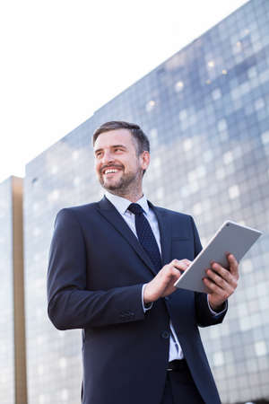 Elegant boss in front of big modern building