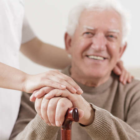 Senior man and helpful nurseの写真素材