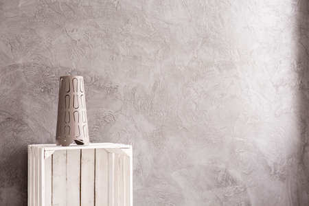 Interior with grey wall, home decoration standing on white, wood box