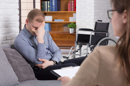 Shot of a disabled young man during a psychotherapy session with his psychologist