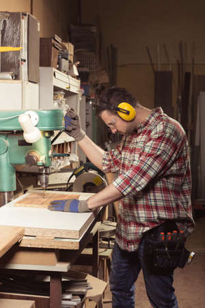 Artisan during work in professional, well equipped workshop.