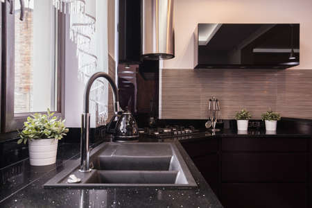 Closeup of countertop and granite sink in brocade kitchen