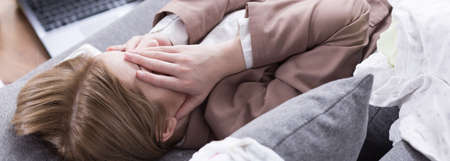 Shot of a young woman covering her faceの写真素材