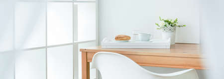 Shot of a modern room full of light with a breakfast on a table