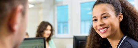 Female student is smiling to her teacherの写真素材