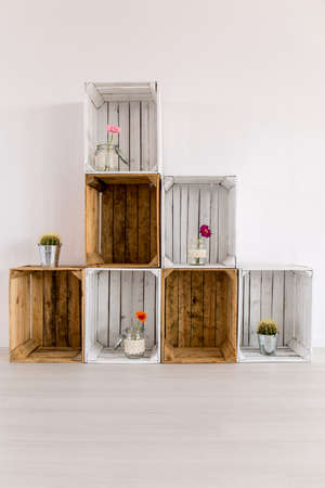 Regale made from brown and white wooden boxes, standing in light interiorの写真素材