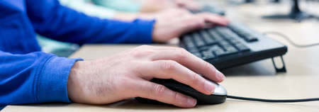 Male hands placed on keyboard and mouse
